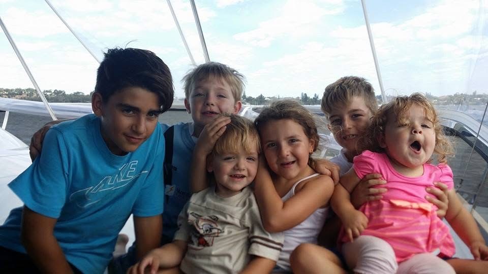 Family and children together on a boat